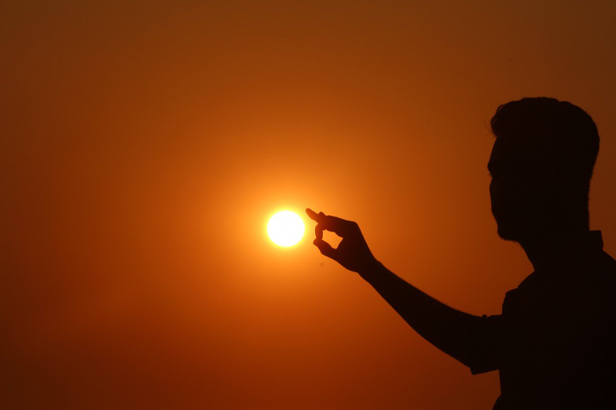 guy is touching the sun