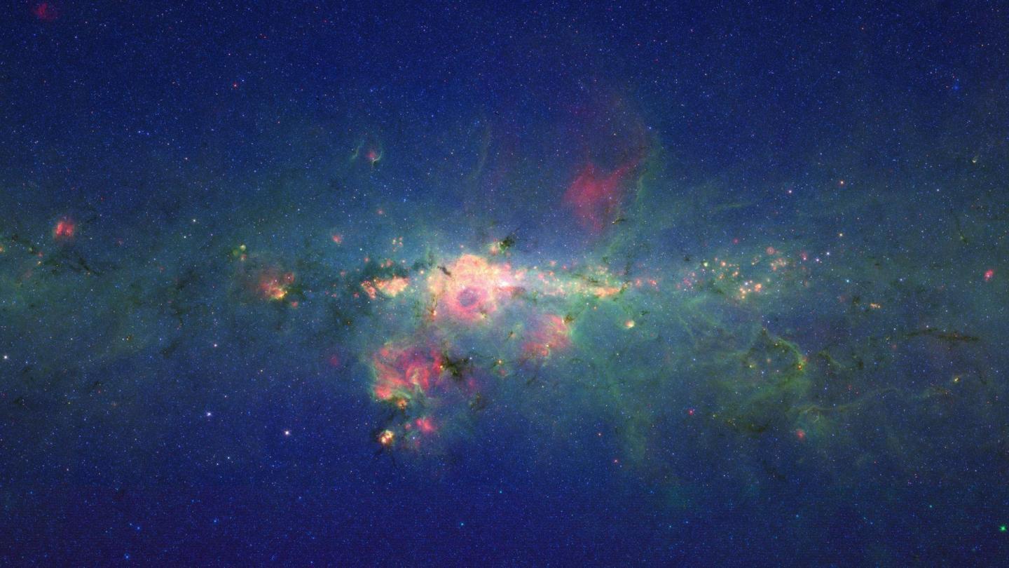 The bustling center of the Milky Way is imaged by the NASA Spitzer Space Telescope.