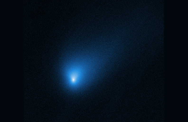 Comet 2I/Borisov appears as a fuzzy blue dot in an image from the Hubble Space Telescope.
